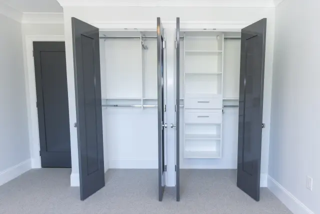 Charcoal double doors open to white hanging and a drawer tower