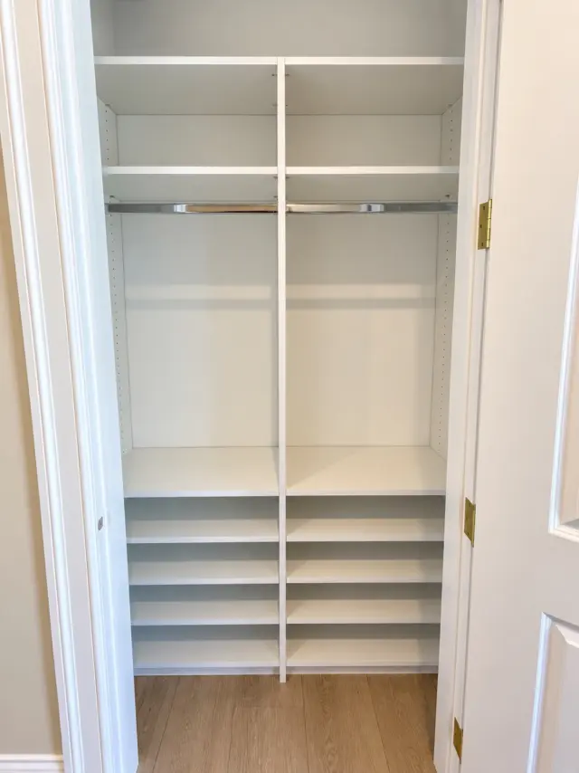 Reach-in closet with double hanging above stacked shoe shelves