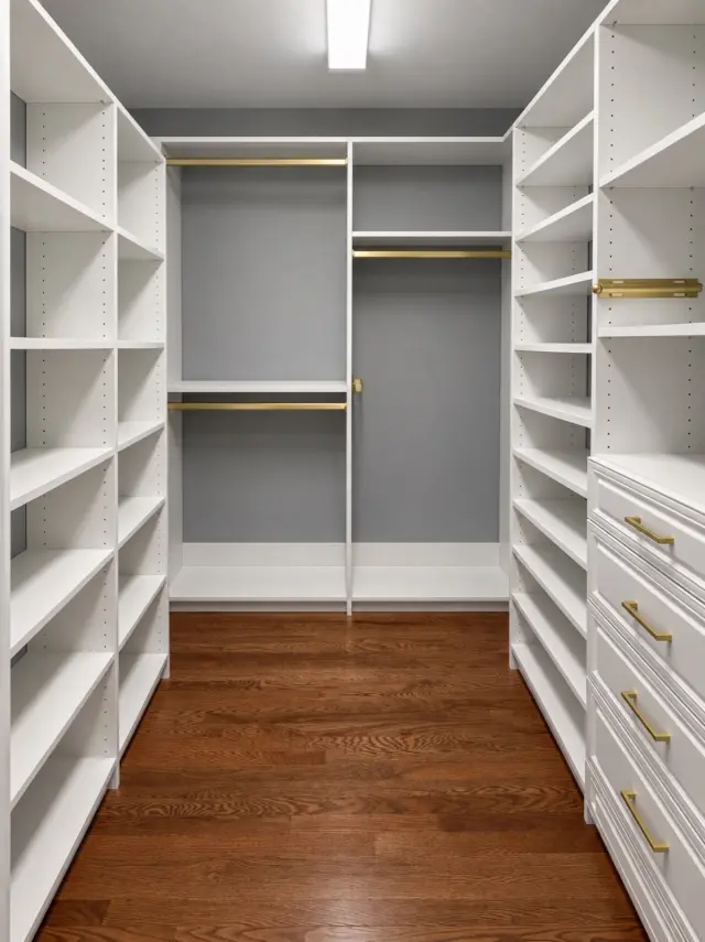 White walk-in closet with shelving on both sides and double hanging at the back wall
