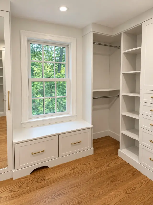 White window seat with drawers between shelving and hanging