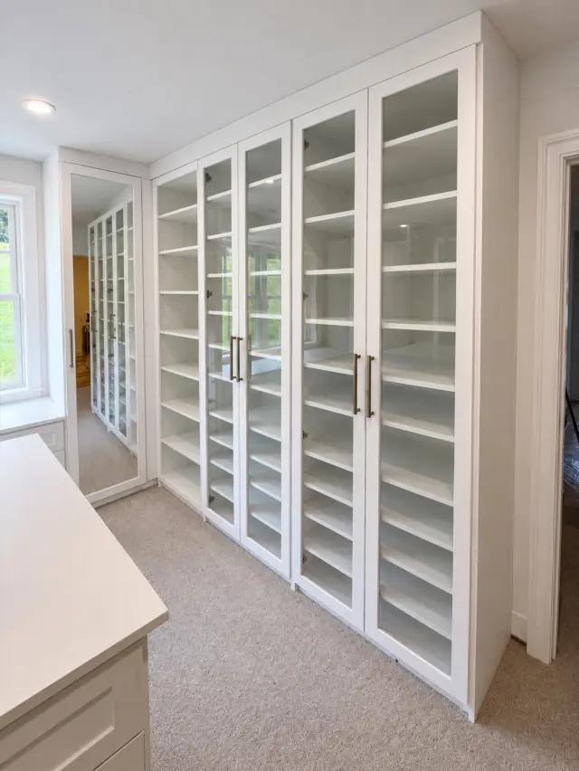 White glass-door cabinets with shoe shelving inside