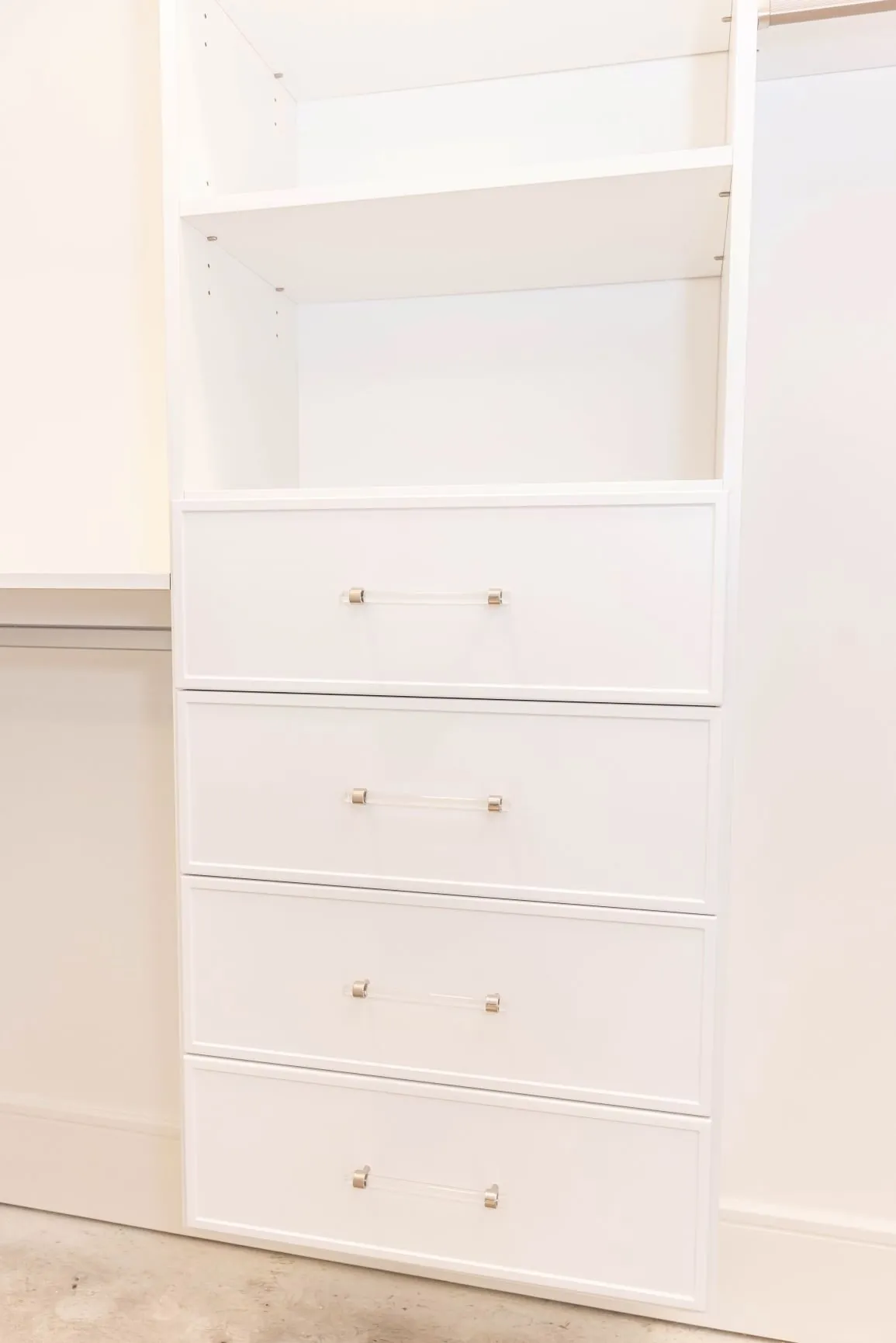 White built-in drawer stack under open shelving