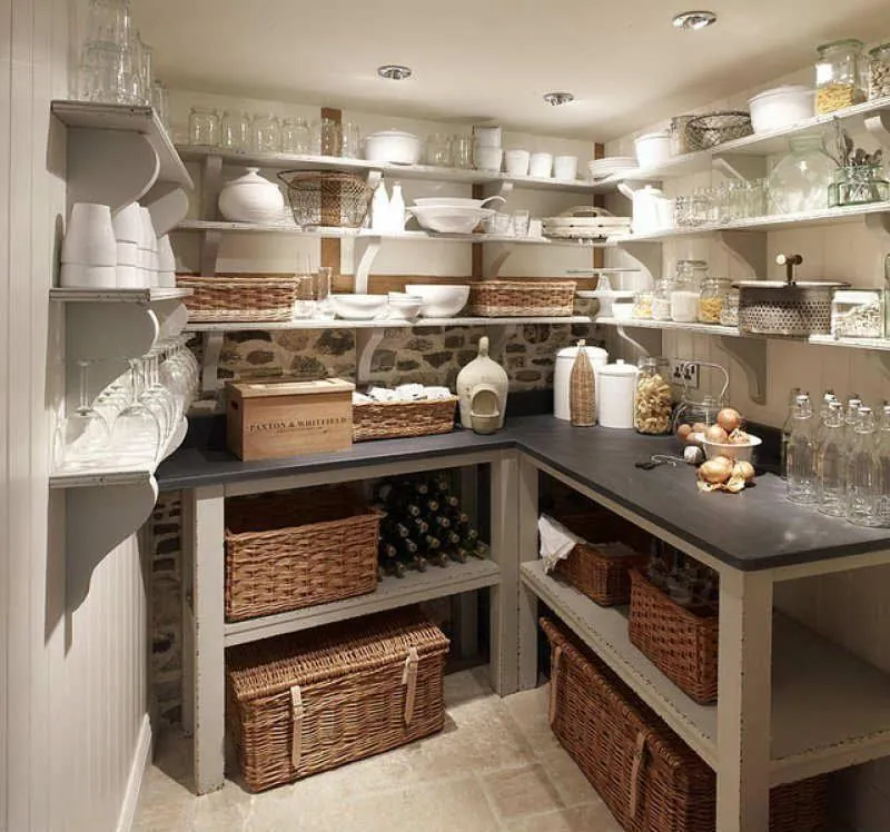 Pantry with open shelves, a dark counter and wicker baskets