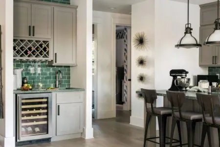 Kitchen bar with glass-front cabinets, a wine rack, a beverage fridge and stools
