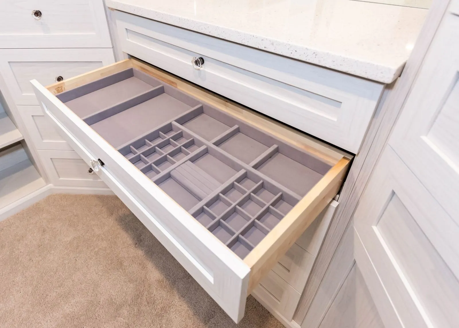 Open drawer with a gray jewelry divider insert