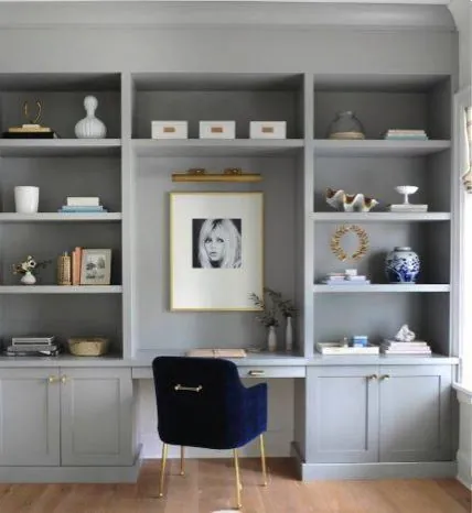 Gray built-in desk with open shelves and cabinets