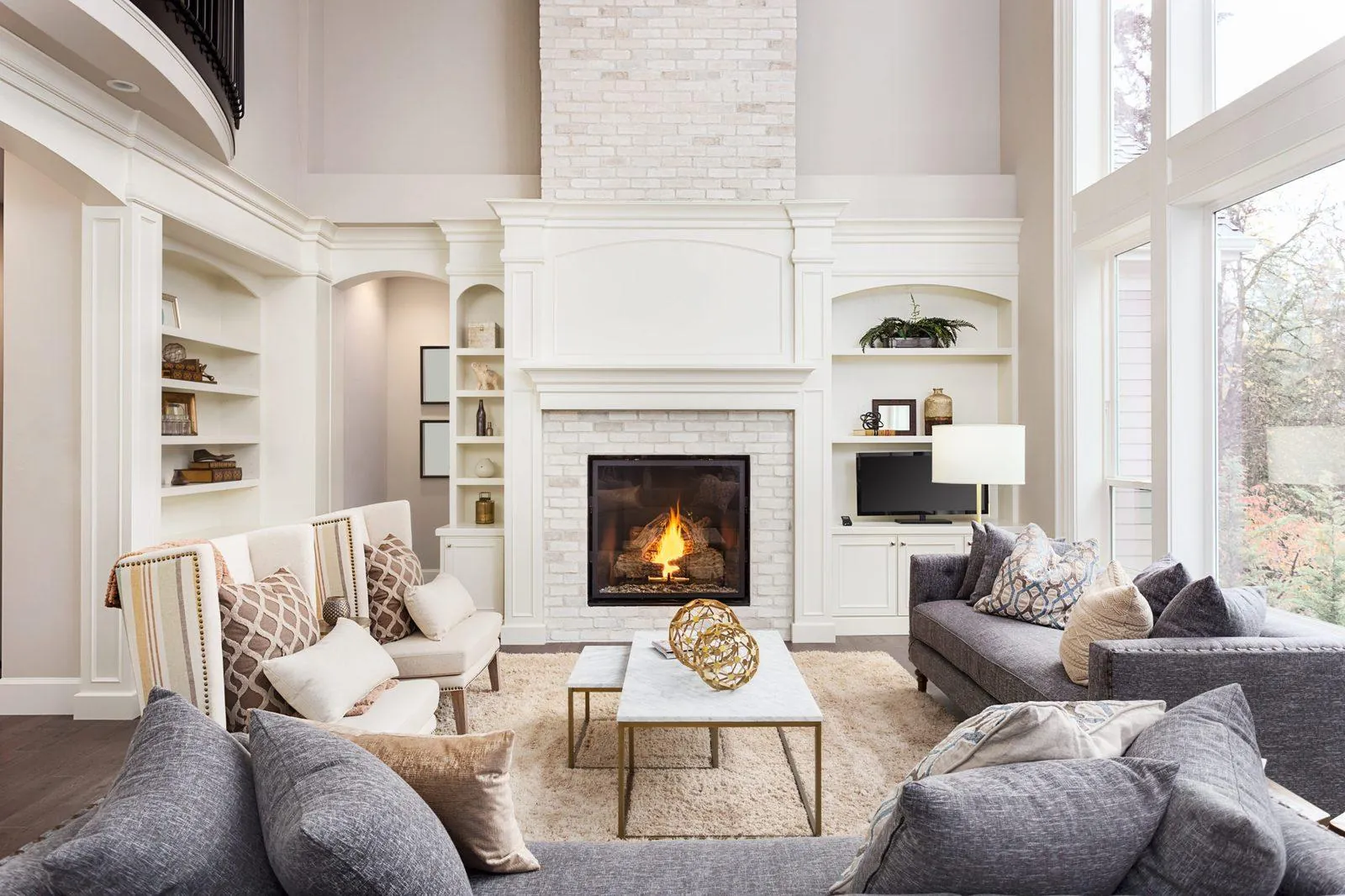 Living room with a fireplace and white built-in shelving