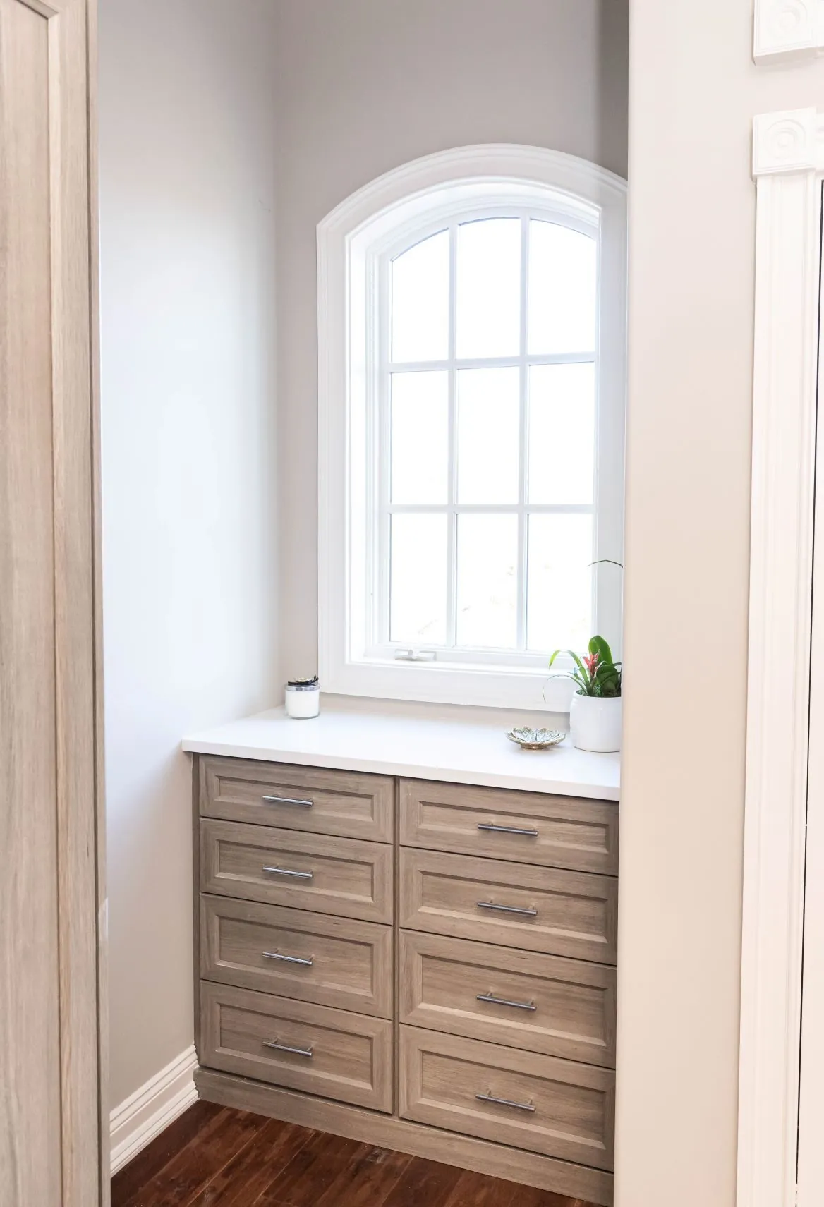 Wood-grain drawer bank under an arched window
