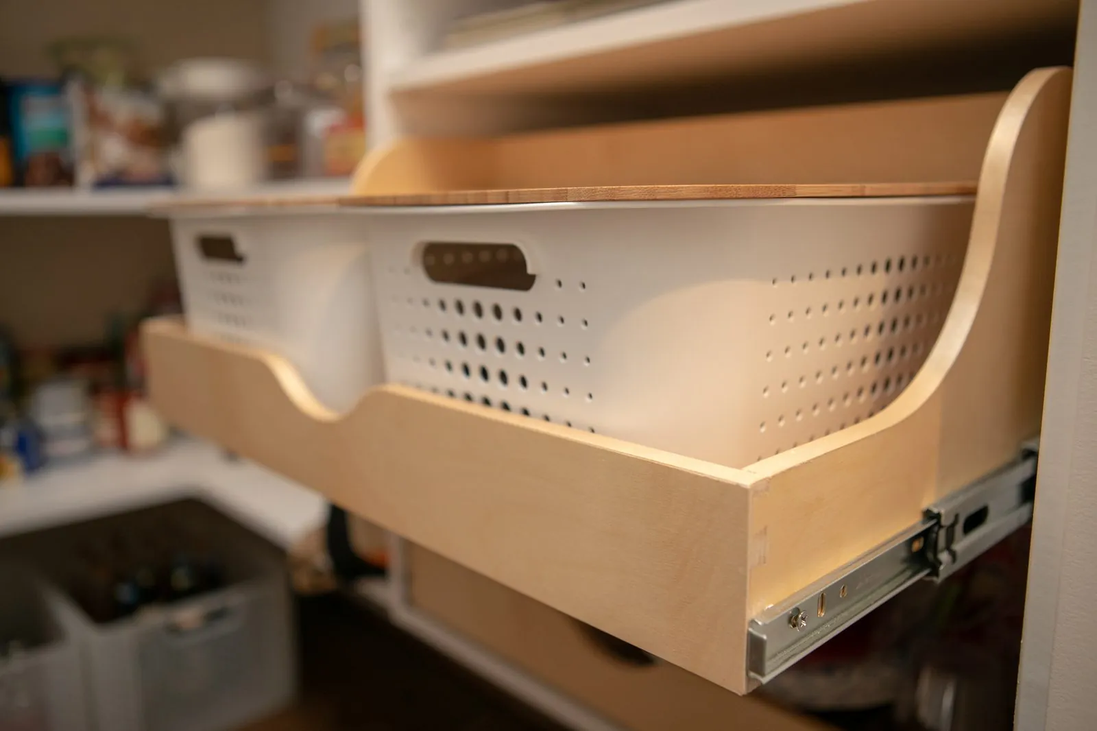 Pull-out wood drawer holding a white basket