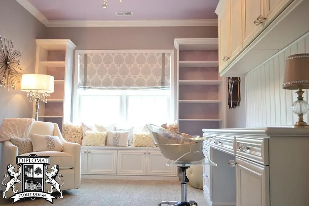 Cream built-in shelving and cabinets around a window seat