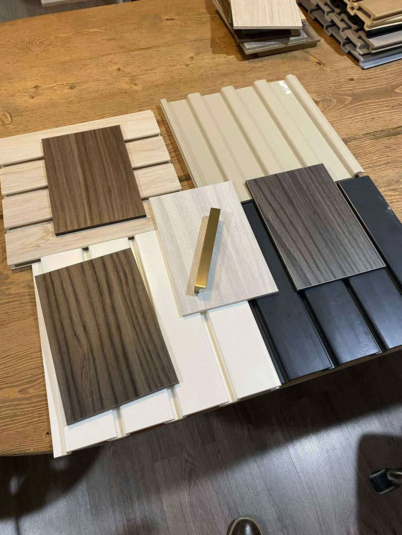 Wood-grain and black finish samples on a table