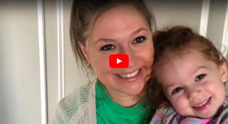 Woman and young girl smiling in a video thumbnail