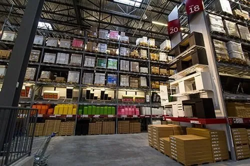 Warehouse aisle with tall shelving stacked with boxes