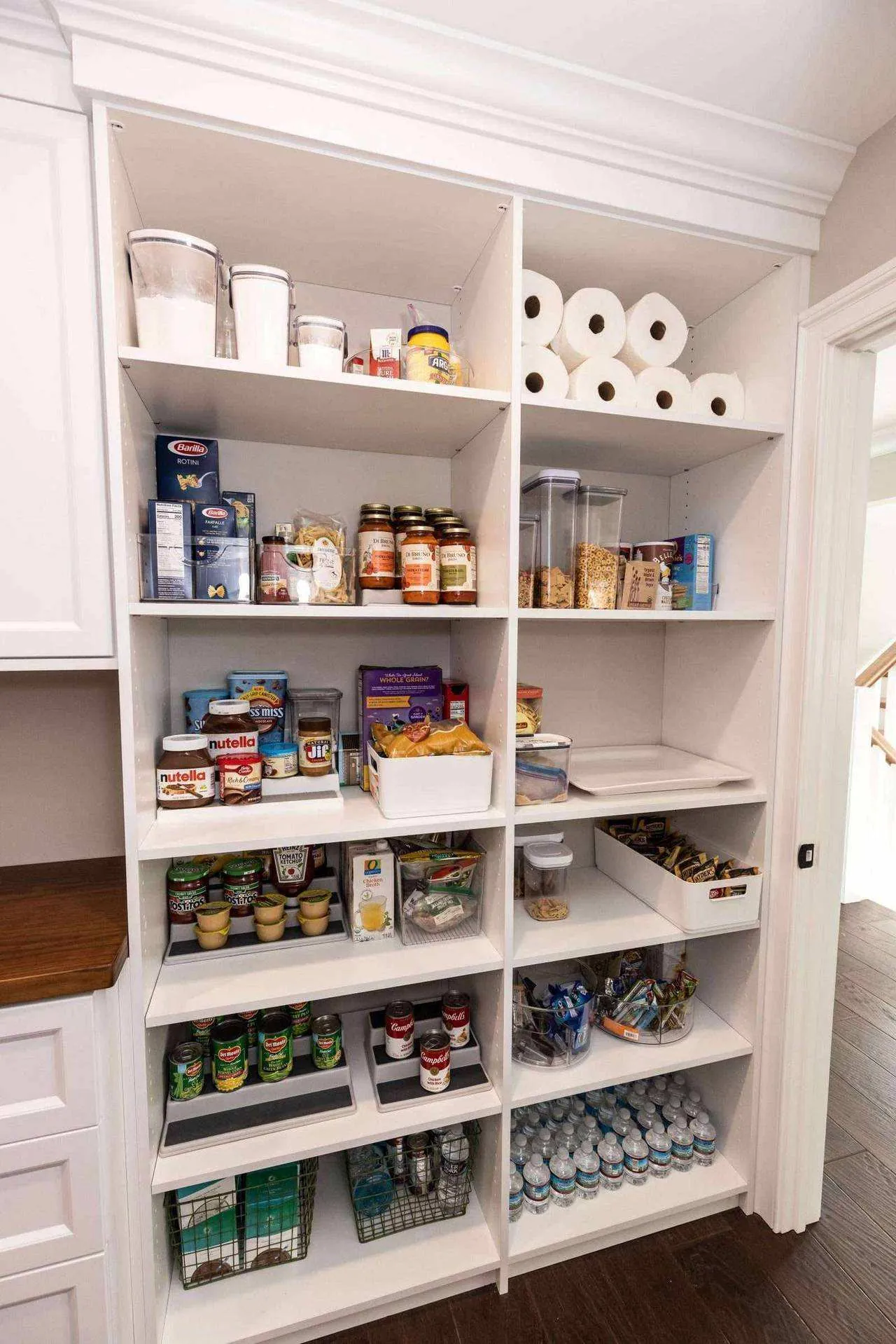 White pantry shelving stocked with food